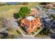 Townhomes with red tile roofs, surrounded by landscaping, parking, and a scenic lake at 8507 Waterview Way, Winter Haven, FL 33884