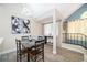 Cozy dining area featuring a modern light fixture, seating for four, and decorative window dressings at 8507 Waterview Way, Winter Haven, FL 33884