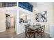 Charming dining room with a modern chandelier, seating for four, and an open view to the kitchen at 8507 Waterview Way, Winter Haven, FL 33884
