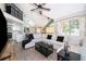 Bright living room featuring vaulted ceilings, a comfortable sofa, and open access to the modern kitchen at 8507 Waterview Way, Winter Haven, FL 33884