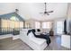 Spacious living room with vaulted ceilings, an L-shaped sectional, and a large window offering natural light at 8507 Waterview Way, Winter Haven, FL 33884