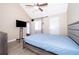 Inviting bedroom featuring vaulted ceilings, wood-look flooring, and a door to a private outdoor area at 8507 Waterview Way, Winter Haven, FL 33884