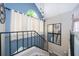 Stairway with high ceilings, statement mirror, and modern railing at 8507 Waterview Way, Winter Haven, FL 33884