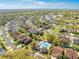 Wide aerial view shows the community pool and clubhouse among a neighborhood of well maintained single-Gathering homes at 1004 Costa Mesa Ln, Kissimmee, FL 34744