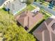 An aerial view of a beautiful single-Gathering home featuring a well maintained brown roof and green landscaping at 1004 Costa Mesa Ln, Kissimmee, FL 34744