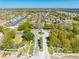 Aerial view of a planned neighborhood featuring lush landscaping, a community roundabout, and convenient roadways at 1004 Costa Mesa Ln, Kissimmee, FL 34744