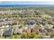 Wide aerial view of a well planned community with mature trees and convenient access to nearby amenities and waterways at 1004 Costa Mesa Ln, Kissimmee, FL 34744