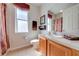 Well-lit bathroom featuring tile floors, decorative window film, and a functional vanity at 1004 Costa Mesa Ln, Kissimmee, FL 34744