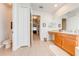 Bright bathroom with a vanity area, a soaking tub, and tile flooring at 1004 Costa Mesa Ln, Kissimmee, FL 34744
