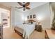 Bright bedroom with a ceiling fan, closet, and two bedside tables offering comfort and style at 1004 Costa Mesa Ln, Kissimmee, FL 34744