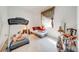 Bright bedroom needing some tidying, featuring a large window and exercise equipment at 1004 Costa Mesa Ln, Kissimmee, FL 34744