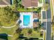 Aerial view of a pristine community pool, surrounded by lush landscaping and convenient amenities at 1004 Costa Mesa Ln, Kissimmee, FL 34744