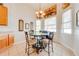 Cozy dining area featuring a chandelier and natural light from the windows at 1004 Costa Mesa Ln, Kissimmee, FL 34744