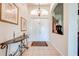 Inviting foyer with neutral tile flooring, double doors, decorative table, and artful details, showcasing the home's elegance at 1004 Costa Mesa Ln, Kissimmee, FL 34744