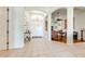 Spacious foyer with tile flooring, arched doorways, and chandelier, seamlessly connecting to a living area with hardwood flooring at 1004 Costa Mesa Ln, Kissimmee, FL 34744
