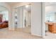 Hallway with a mirrored closet, leading to the bedroom and bathroom at 1004 Costa Mesa Ln, Kissimmee, FL 34744