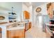 View of kitchen with stainless steel appliances and an open floor plan leading to the living room at 1004 Costa Mesa Ln, Kissimmee, FL 34744