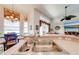 Kitchen featuring a stainless steel double sink and a breakfast bar with views to living room at 1004 Costa Mesa Ln, Kissimmee, FL 34744