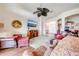 Comfortable living room boasts a large wall-mounted TV, hardwood floors, and a ceiling fan at 1004 Costa Mesa Ln, Kissimmee, FL 34744