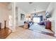 Open-concept living room with hardwood flooring, a ceiling fan, and sliding glass doors leading to the outdoor space at 1004 Costa Mesa Ln, Kissimmee, FL 34744