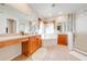 Bright main bathroom featuring a soaking tub and a glass-enclosed shower at 1004 Costa Mesa Ln, Kissimmee, FL 34744