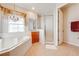 Main bathroom featuring a soaking tub, and a glass-enclosed shower at 1004 Costa Mesa Ln, Kissimmee, FL 34744
