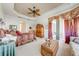 Main bedroom with a ceiling fan, balcony access, and decorative furnishings at 1004 Costa Mesa Ln, Kissimmee, FL 34744