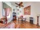 Comfortable office with hardwood floors, a ceiling fan, a work desk and tasteful décor, perfect for a productive work environment at 1004 Costa Mesa Ln, Kissimmee, FL 34744