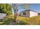 A tree's shade graces the grassy backyard of this charming single-story home at 1013 Cannes Dr, Kissimmee, FL 34759