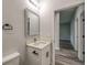 Well-lit bathroom featuring a vanity with storage, a mirror, and neutral walls at 1013 Cannes Dr, Kissimmee, FL 34759