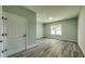 A cozy bedroom featuring hardwood floors, a window, and a neutral color palette at 1013 Cannes Dr, Kissimmee, FL 34759