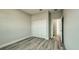 Bedroom featuring wood-look floors and a closet with white double doors at 1013 Cannes Dr, Kissimmee, FL 34759