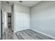 Spacious bedroom featuring wood-look floors and a closet with white double doors at 1013 Cannes Dr, Kissimmee, FL 34759