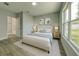 Comfortable bedroom featuring soft tones, a plush bed, and a large window with backyard views at 1013 Cannes Dr, Kissimmee, FL 34759