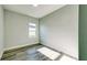 Bright bedroom featuring wood-look floors, neutral paint, and a window at 1013 Cannes Dr, Kissimmee, FL 34759