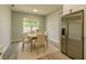 Bright dining area featuring a table with seating for four and stainless steel refrigerator at 1013 Cannes Dr, Kissimmee, FL 34759