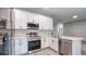 Modern kitchen with stainless steel appliances, white cabinets, and quartz countertops; ready for cooking at 1013 Cannes Dr, Kissimmee, FL 34759