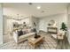 Cozy living room with modern furniture, open to dining area and kitchen, perfect for entertaining at 1013 Cannes Dr, Kissimmee, FL 34759