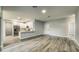 A modern living area with hardwood floors seamlessly connects to the adjacent kitchen space at 1013 Cannes Dr, Kissimmee, FL 34759