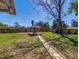 Expansive backyard featuring a gazebo, lush lawn, and a stone pathway at 103 W Maple St, Davenport, FL 33837
