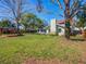 Large backyard with a covered gazebo, a well-maintained lawn, and mature trees at 103 W Maple St, Davenport, FL 33837