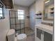 Modern bathroom featuring a walk-in shower, stone pebble floor, and a sleek vanity at 103 W Maple St, Davenport, FL 33837