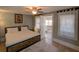 Well-lit bedroom with a ceiling fan and a large window for natural light at 103 W Maple St, Davenport, FL 33837