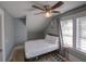 Cozy bedroom featuring a ceiling fan, window with blinds, and simple decor for a comfortable retreat at 103 W Maple St, Davenport, FL 33837