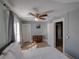Comfortable bedroom with fan, dresser, and light-filled window offers a relaxing retreat at 103 W Maple St, Davenport, FL 33837