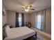 Inviting bedroom with a ceiling fan, natural light from large windows, and neutral tones for a relaxing atmosphere at 103 W Maple St, Davenport, FL 33837