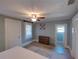 Cozy bedroom with wood floors, ceiling fan, and a view to an adjacent bathroom at 103 W Maple St, Davenport, FL 33837