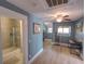 Upstairs bedroom with a bathroom, laminate flooring, and a ceiling fan at 103 W Maple St, Davenport, FL 33837