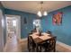 Cozy dining room with classic furniture and artwork on the walls at 103 W Maple St, Davenport, FL 33837