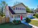 Inviting two-story home with brick exterior, red front door, and lush landscaping at 103 W Maple St, Davenport, FL 33837